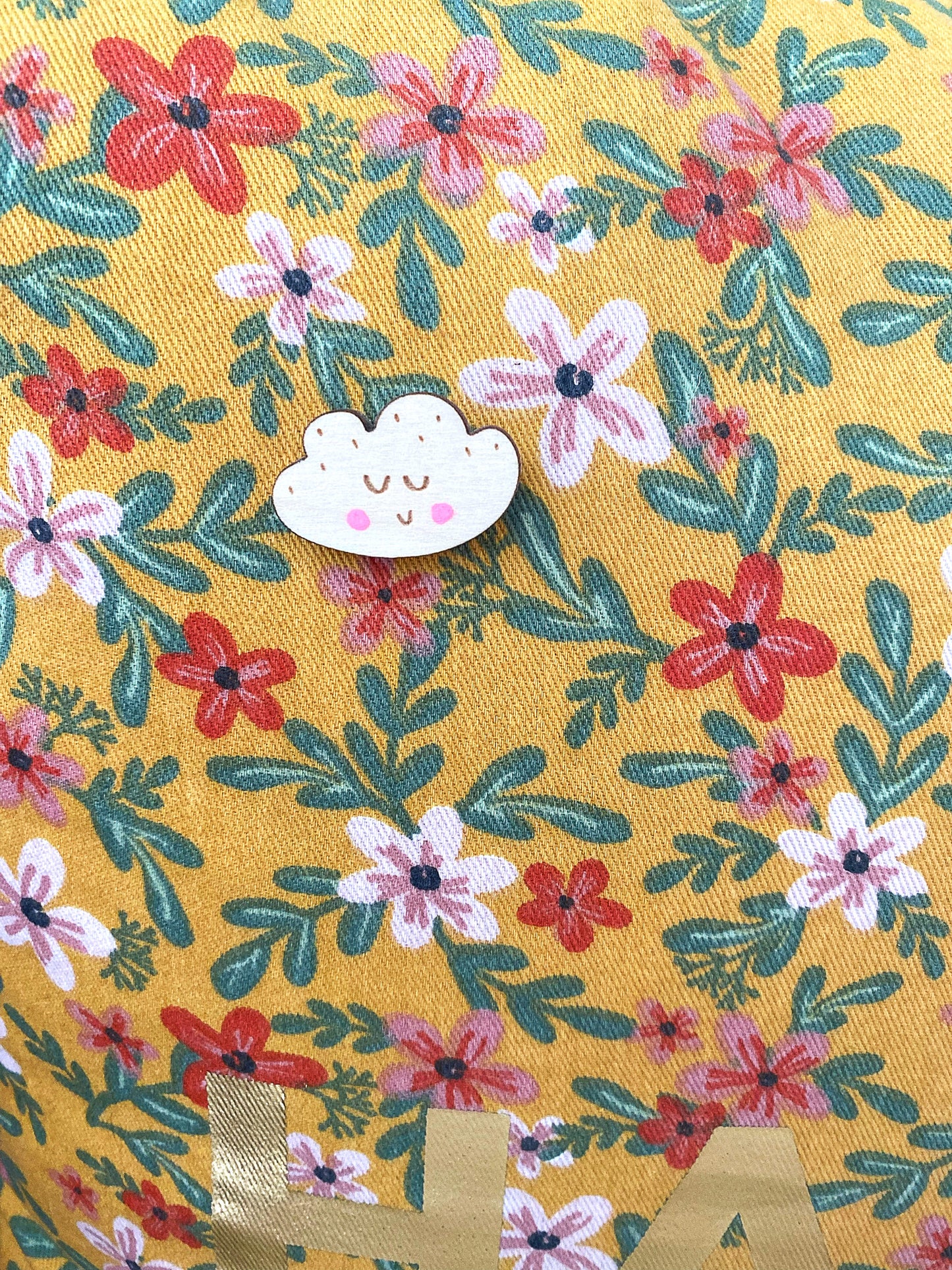 Smiley cloud pin badge